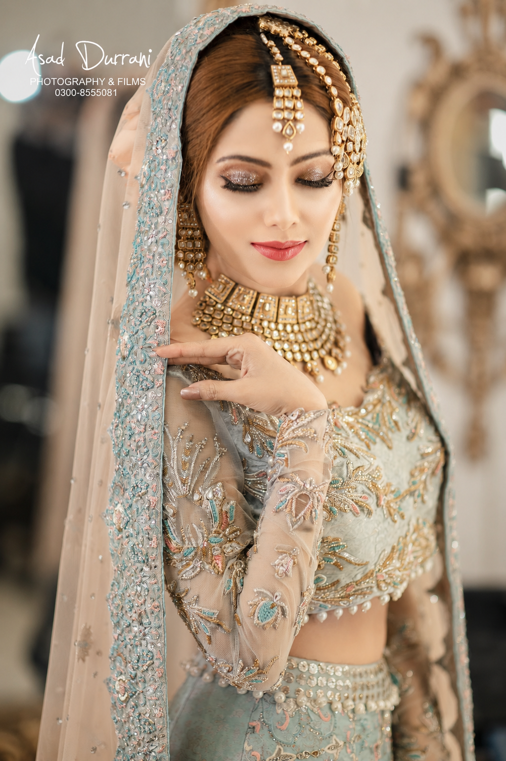 Bridal portrait in teal and gold embroidered lehenga