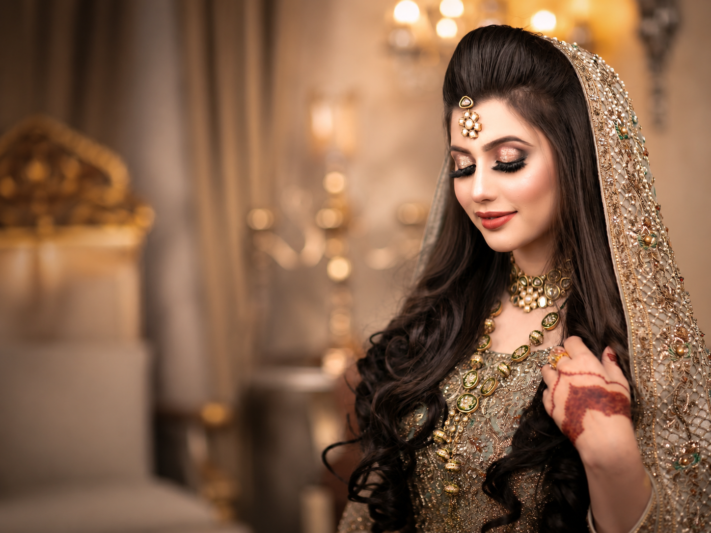 Bridal portrait with embroidered veil and mehndi hand
