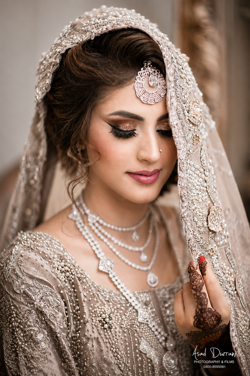 Bridal portrait in ivory beaded veil with mehndi detail