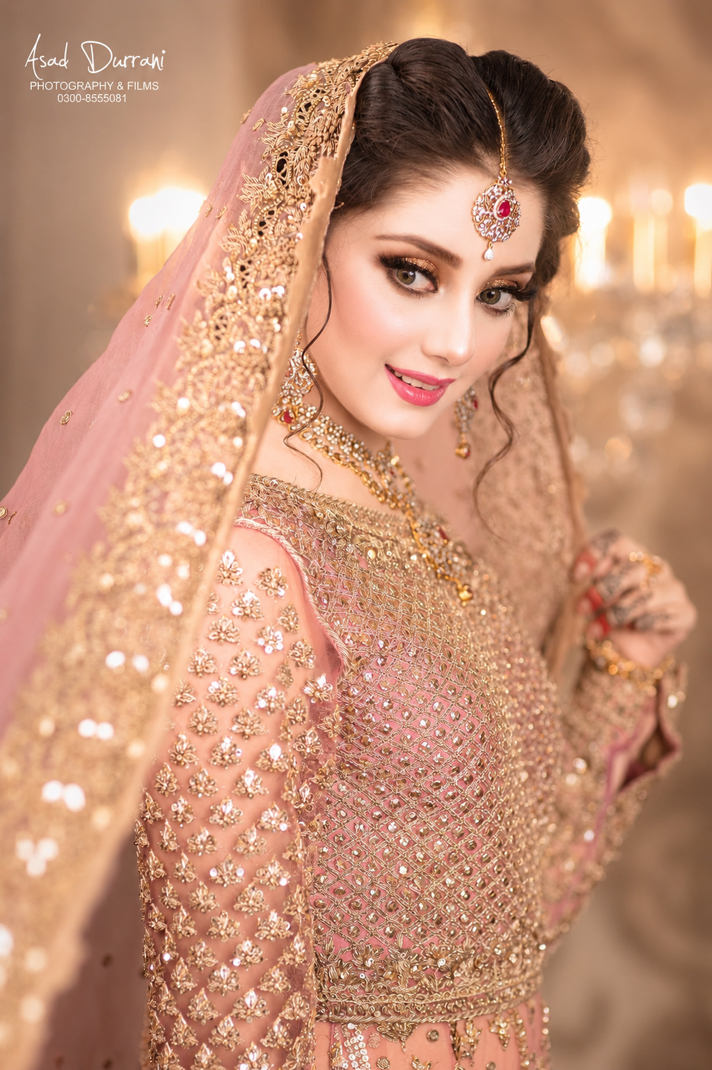 Bridal portrait in pink and gold embroidered veil